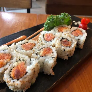 a plate of sushi and chopsticks