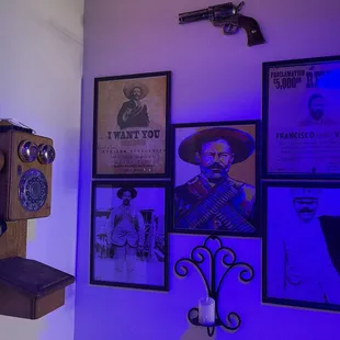 a wall with posters and a telephone