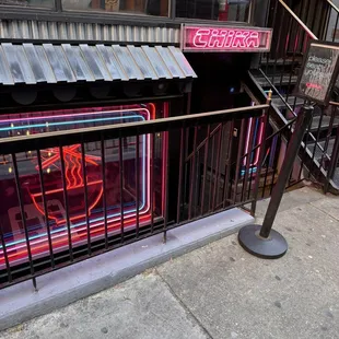 a neon sign on the side of a building