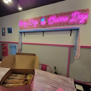 a person holding a box of churros