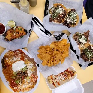 Left to Right Birria Taco, Chicken Enchilada plate, Elote, Tortilla Chips, Tacos (Lengua, Cavesa, Carnitas, Asada)