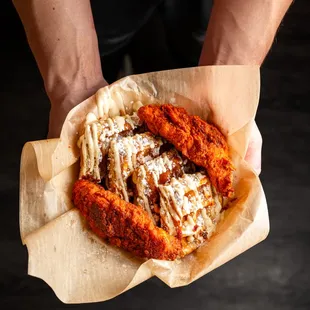 a person holding a basket of food