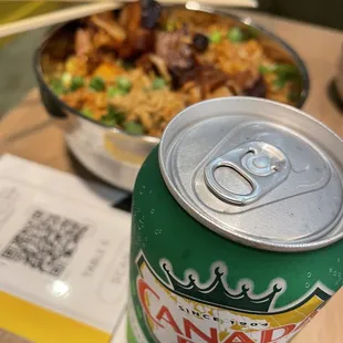 a can of beer and a bowl of food