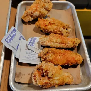 a tray of fried chicken wings on a table