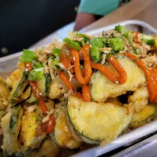 a plate of food with vegetables and sauce