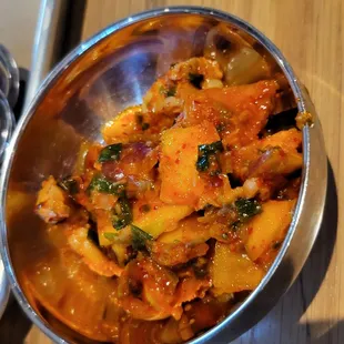a bowl of food on a wooden table