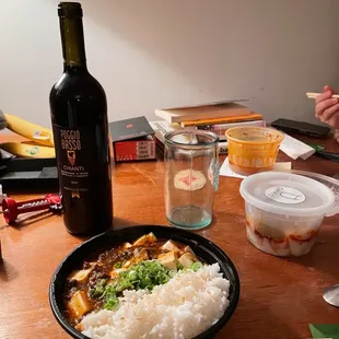 a bowl of rice and a bottle of wine