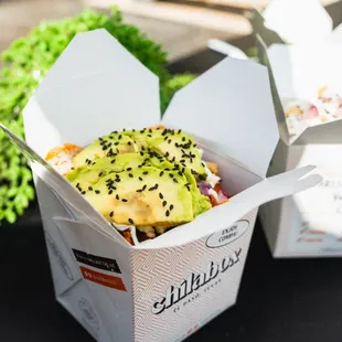 two take out boxes of food on a table