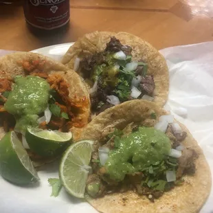 three tacos on a white plate