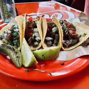 Carne asada y pastor tacos.