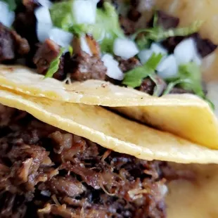 Barbacoa taco and asada taco con queso