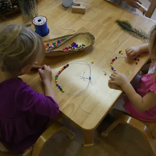 Making bead necklaces.