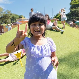 Jack &amp; Jill Hill is a bright green sliding hill that encourages physical and imaginative play.