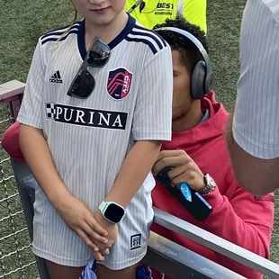 Team member autographing a kids shirt