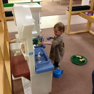 Cooking up something yummy at the toy kitchen