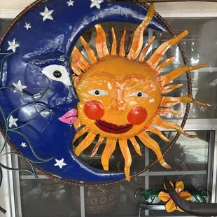 a sun and moon on a window sill