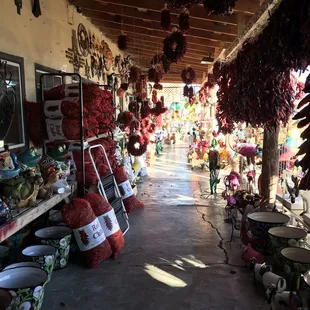 a market with chili hanging from the ceiling