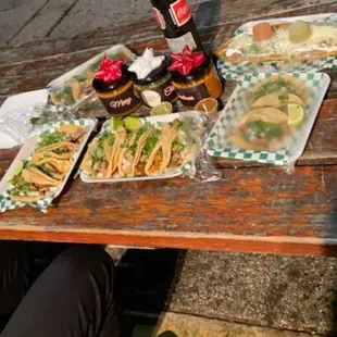 a person sitting at a picnic table with food