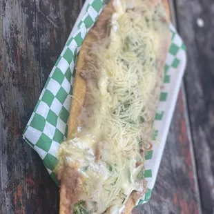 a hot dog with cheese and onions