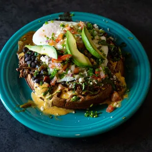 Blue Corn Tostada 
queso salsa - black beans - choice of protein - red or green chile - eggs style 
*available for brunch*