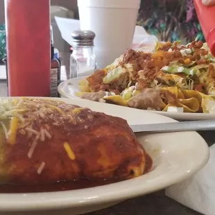 Burrito with al pastor meat and I went Christmas with red and green sauce. Al pastor Nachos in the back ground.