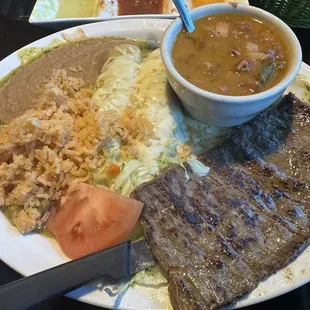 1.12.24 Todays special: sweet tea with Enchiladas verdes, skirt steak, rice, refried beans, and salad.  paid $1 for borracho beans