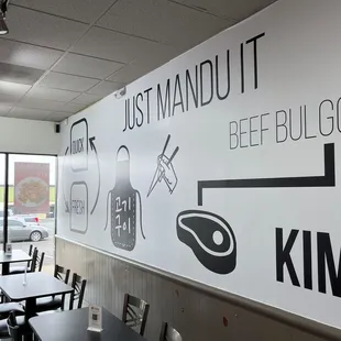 a restaurant with a large sign on the wall