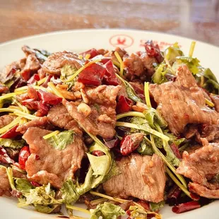 a plate of food with meat and vegetables