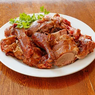 a plate of meat on a wooden table