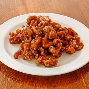 a white plate of food on a wooden table