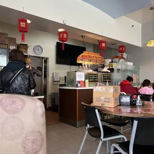 people sitting at tables in a restaurant