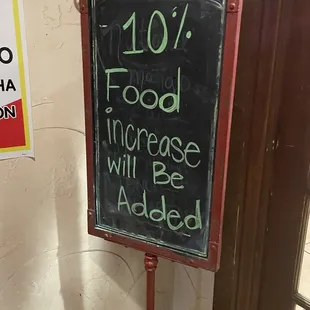 a chalkboard with the words 10 % food increase will be added