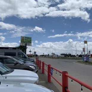 a row of cars parked on the side of the road