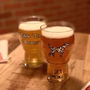 two glasses of beer on a table