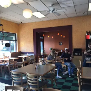 people sitting at tables in a restaurant