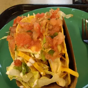 a taco on a plate with a fork
