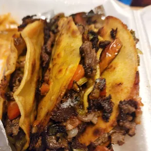 a plate of tacos and fries