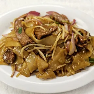 beef and noodles on a white plate