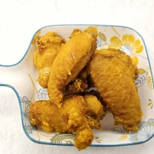 a plate of fried chicken wings