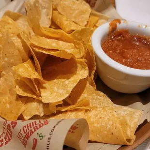 a plate of chips and a bowl of salsa