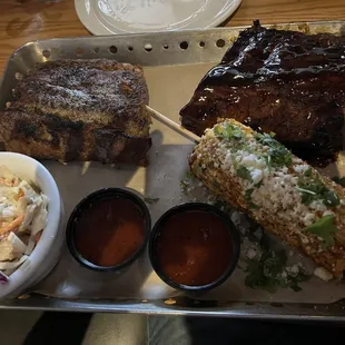Full Rack of Ribs dry rub on left and honey habanero on right with coleslaw and street corn.