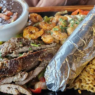 My wife got the Fajita Trio: Chicken, Steak &amp; Shrimp (Auminum foil wrapper contains rolled tortillas).