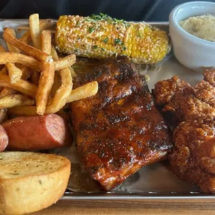 Smokehouse Combo: Ribs, Jalapeno Cheddar Smoked Sausage, Honey Chipotle Crispy Chicken Crispers, corn and mashed potatoes.