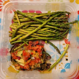 a plate of asparagus and tomatoes