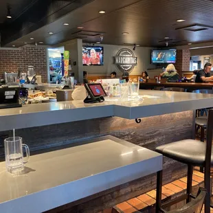 a restaurant with a counter and bar