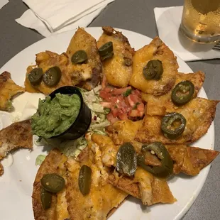 Classic nachos w/chicken and guacamole, both extra charge. Disgusting to even look at, and worse to eat.
