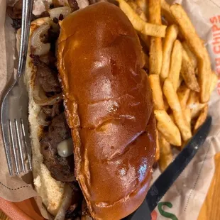 Philly cheesesteak comes on a buttery, soft roll loaded with steak, queso onions, green bell peppers and jalapeños