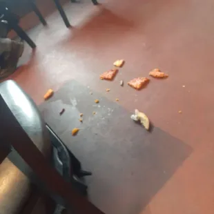 Many dirty tables... Food on the floor... Waitress walking on the food on the floor.... Disgusting