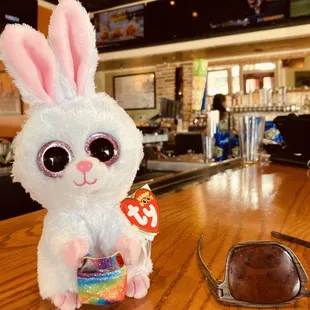 a stuffed bunny and sunglasses on a table