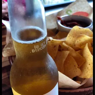 Thin salty chips and salsa with a ice cold Corona and lime.